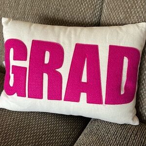 GRAD pillow.  Beige with dark pink letters.  Brand new by Alexandra Ferguson!